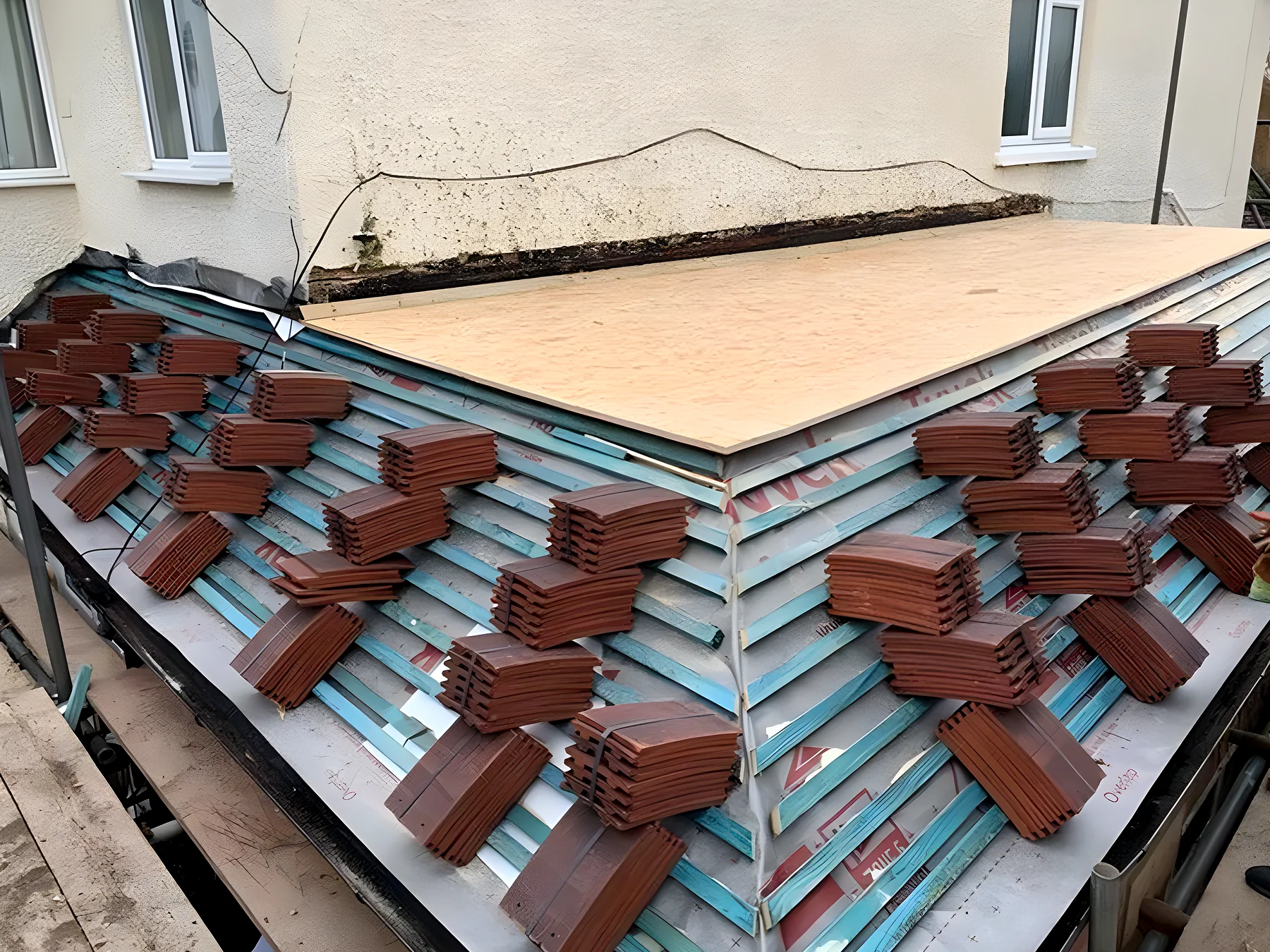 Clay tiles loaded out on new battens, the kind of detail an itemised quote describes