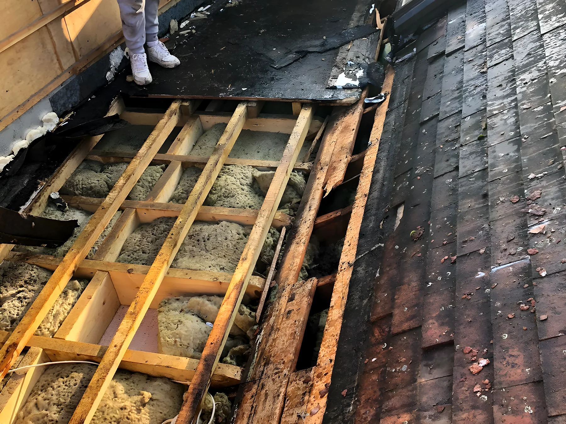 A flat roof stripped back so the deck can be inspected