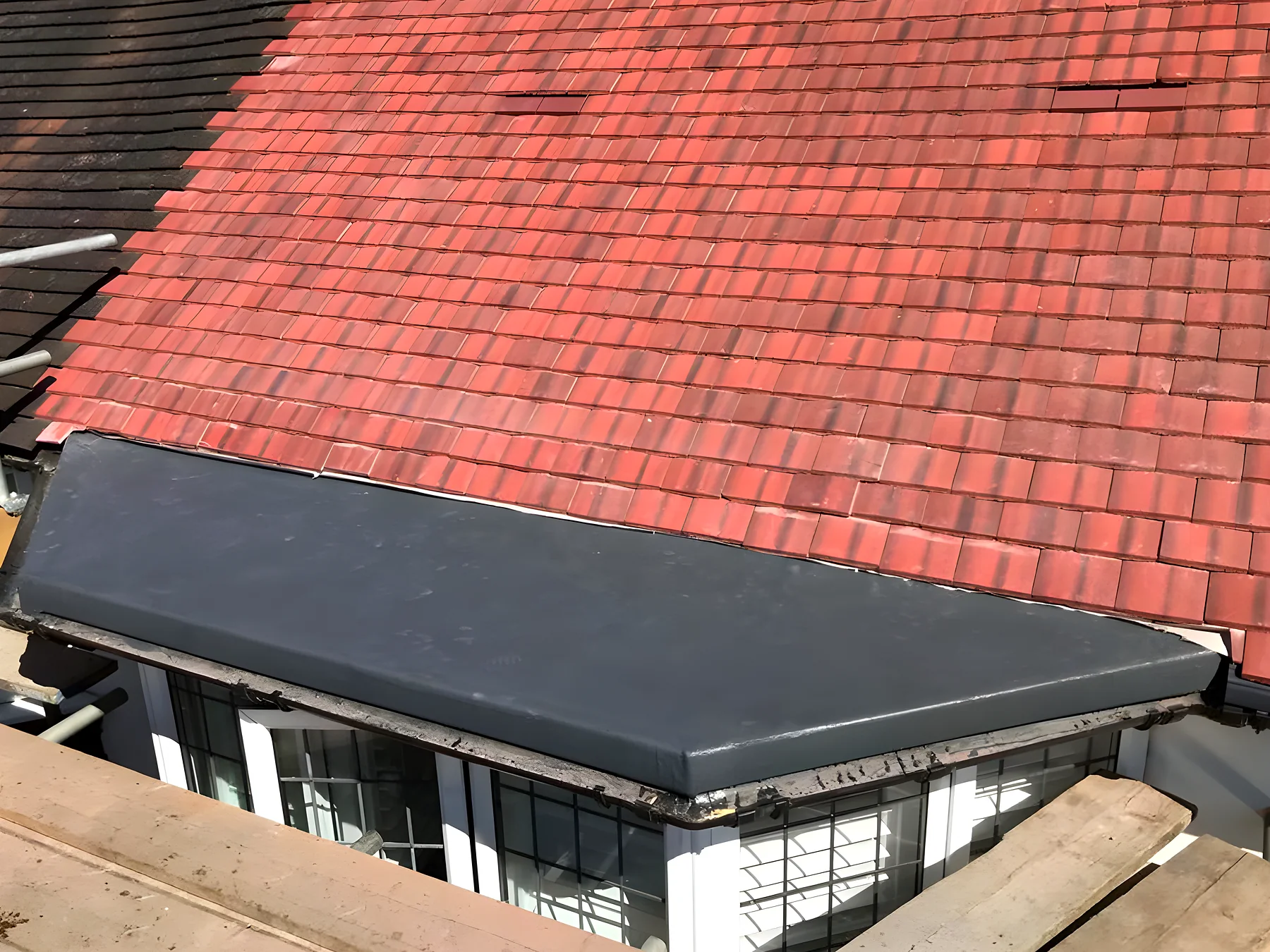 Finished grey GRP flat roof laid to a fall
