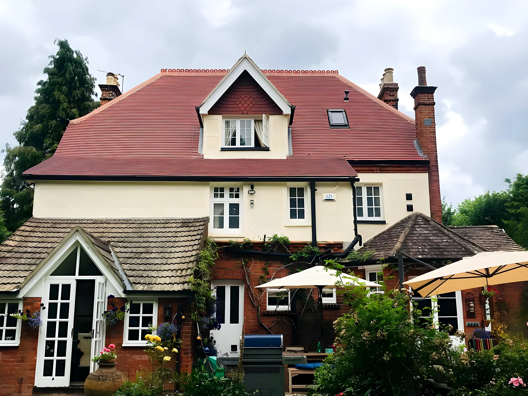 Period house with a new red clay tiled roof, one of our re roofs