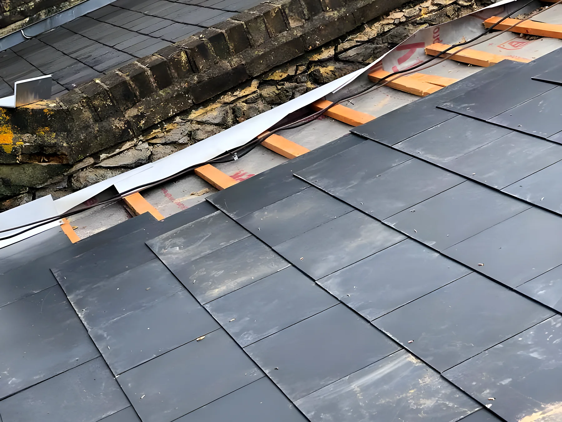 Slate roof stripped back so the battens and felt can be inspected